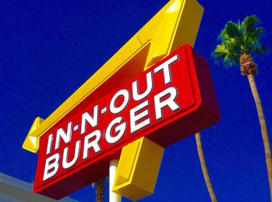 In-N-Out's founder, Harry Snyder, was inspired by one of his favorite movies, "It's a Mad, Mad, Mad, Mad World." He wanted to create a place where people could find treasures buried under four crossed palm trees planted in front of every location.