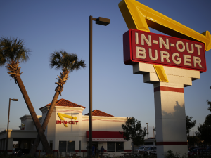 In-N-Out's founder, Harry Snyder, was inspired by one of his favorite movies, "It's a Mad, Mad, Mad, Mad World." He wanted to create a place where people could find treasures buried under four crossed palm trees planted in front of every location.