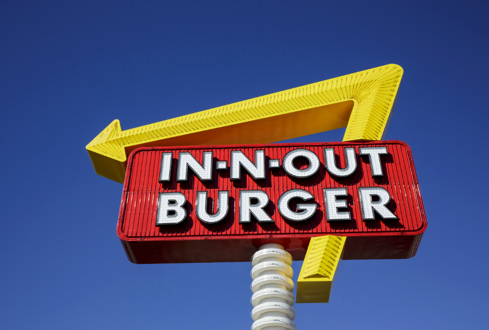 In-N-Out's founder, Harry Snyder, was inspired by one of his favorite movies, "It's a Mad, Mad, Mad, Mad World." He wanted to create a place where people could find treasures buried under four crossed palm trees planted in front of every location.